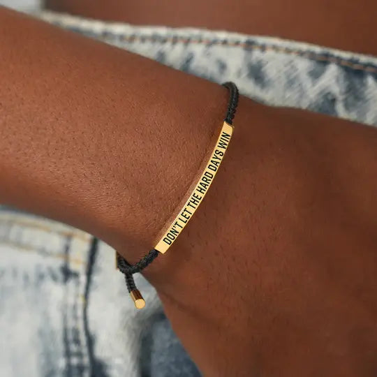 Gold bar bracelet worn on the wrist