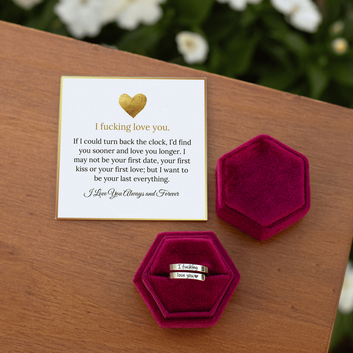 Message card and open gift box on a wooden table